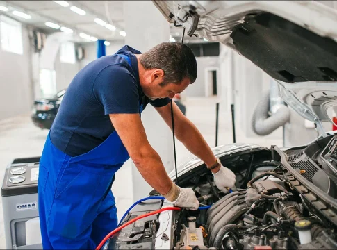 A car mechanic repairs a car
