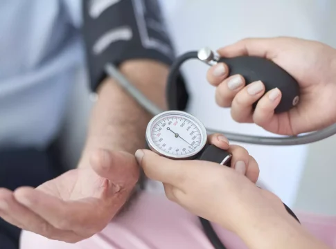 A doctor measures a man's blood pressure