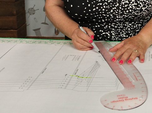 A woman uses a ruler