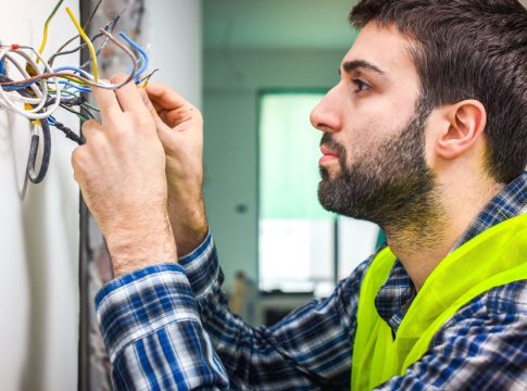 An electrician works on home installations