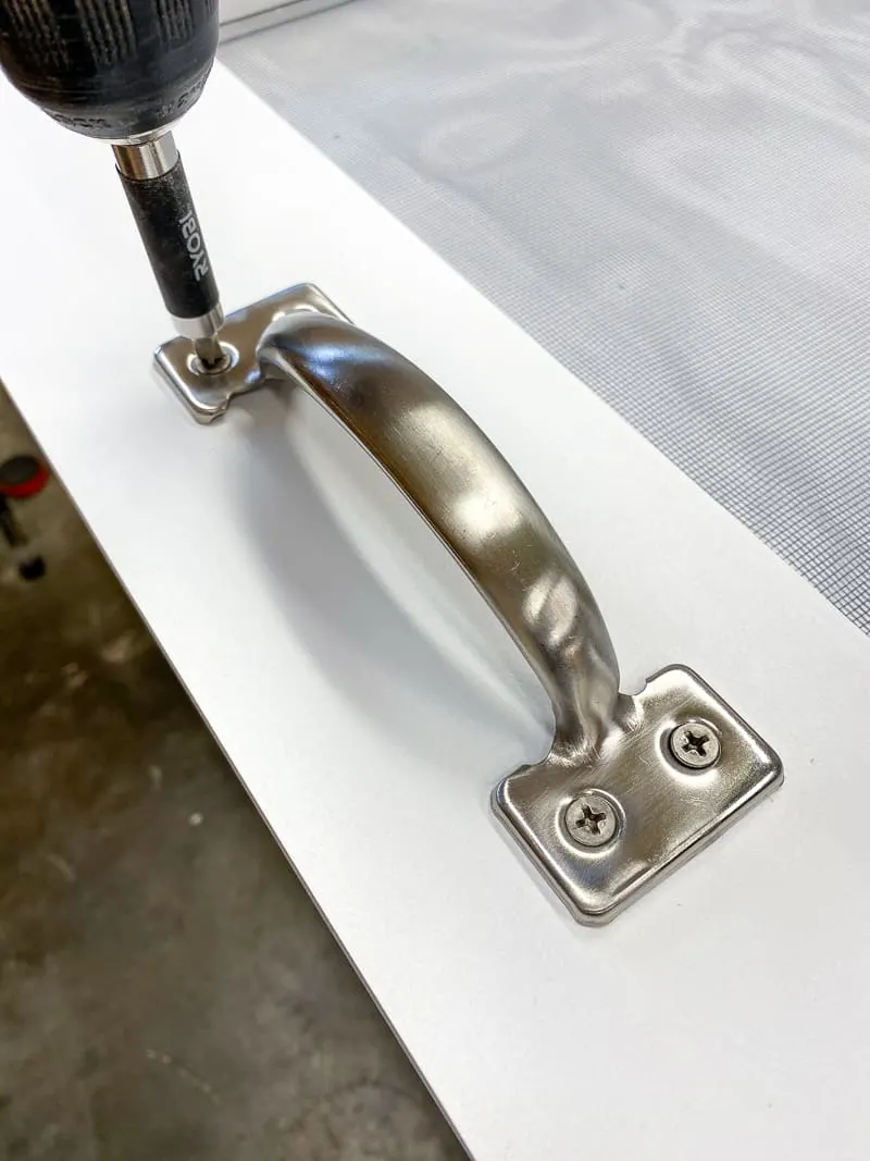 Attaching the handle to the front of the screen door