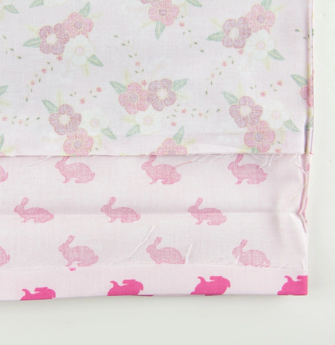 Raw edge of the dress banded towards the wrong side of the fabric